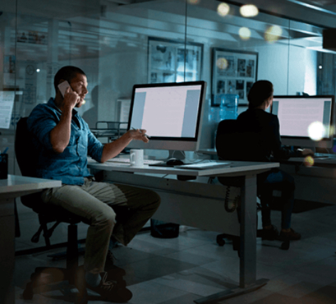 man on the phone in a glass office